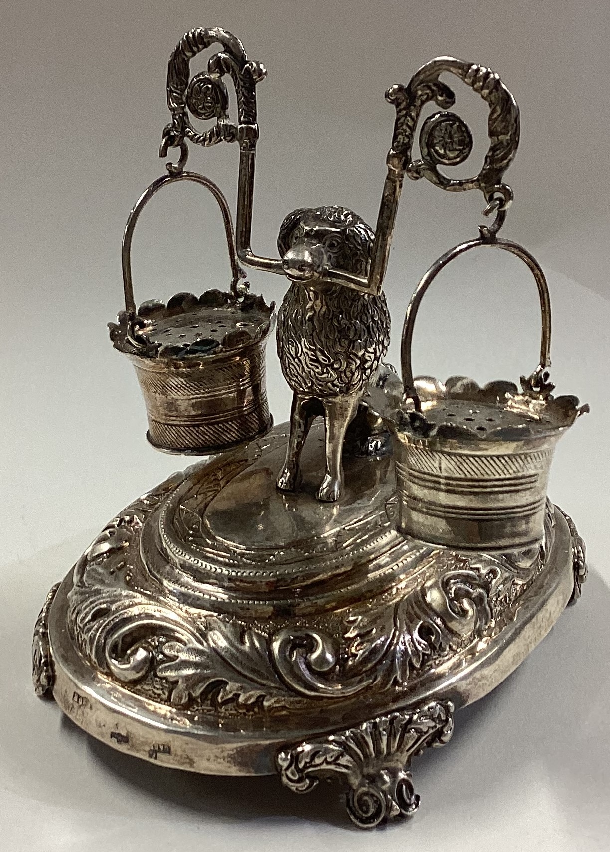 A Portuguese silver toothpick holder with figure of a dog holding a milkmaid's yoke and pails.