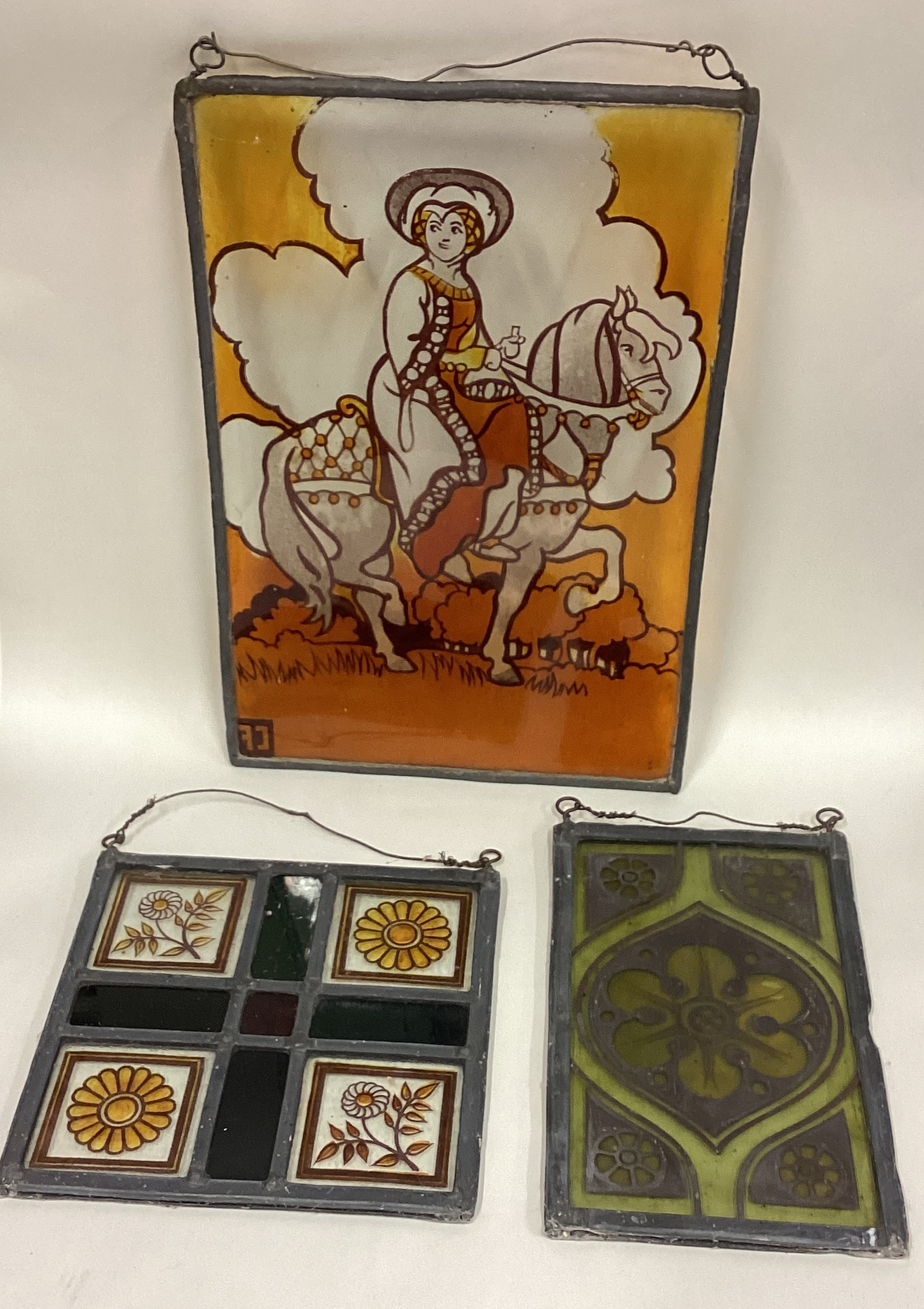 A group of three stained glass panels.