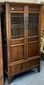 A Continental hardwood two-door cabinet Est. £60 -