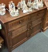 A carved oak two-door sideboard.