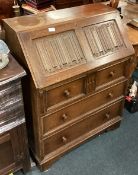A carved oak bureau.