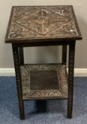 A small carved oak table.