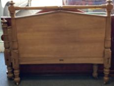 A mahogany panelled bed frame.
