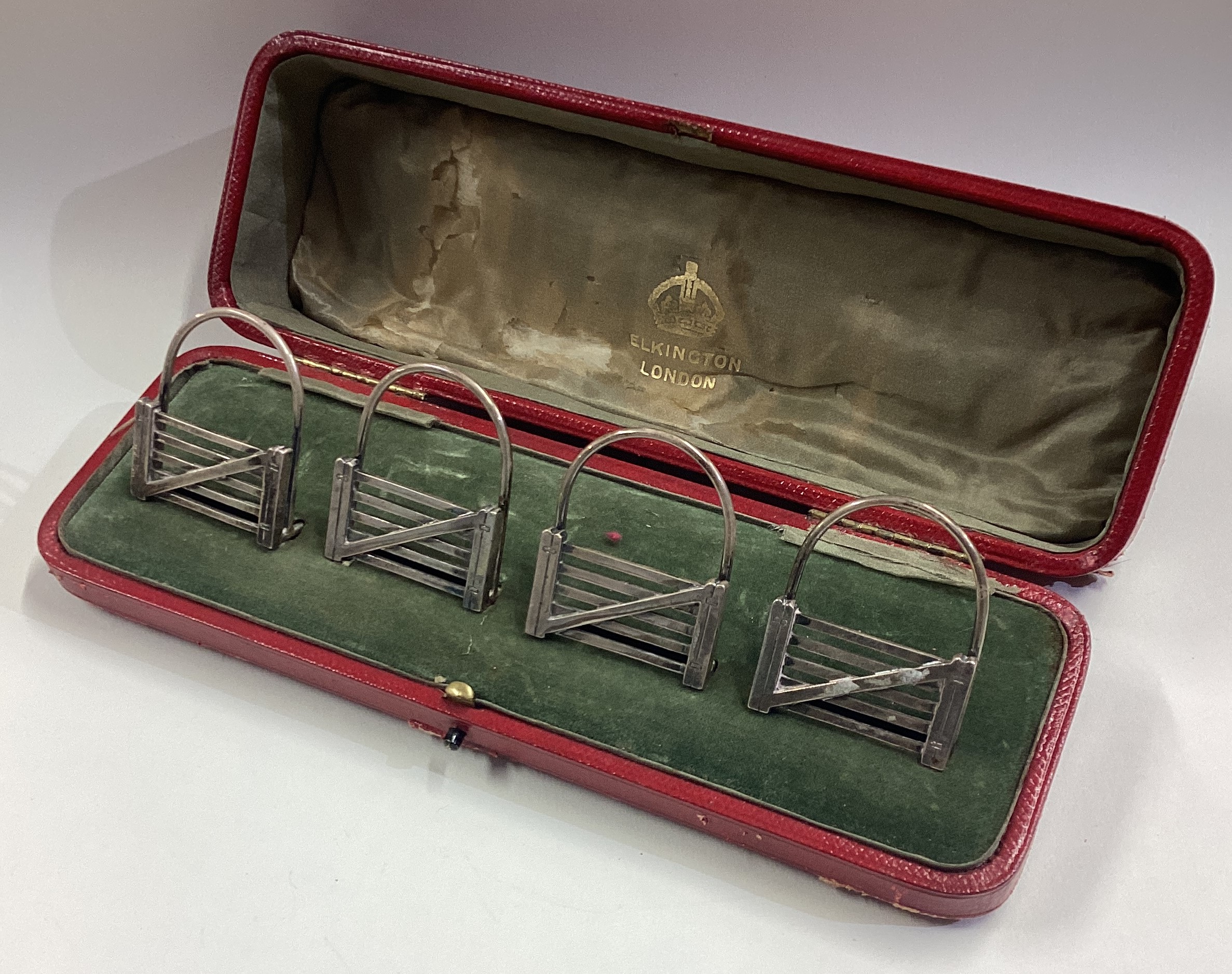 A fine set of four silver menu holders in the form of five-bar gates contained within original box.