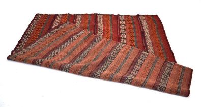 A Turkish kilim with repeated rows of motifs on red and orange grounds, 166 x 177 cm Minor wear