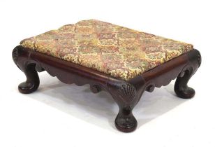 A Georgian mahogany footstool with a later embroidered surface, shell caps and pad feet, later