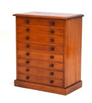 An early 20th century stained pine eight-drawer collectors cabinet on a plinth base, 45 x 27 x 56 cm