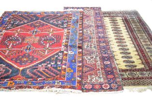 A Bokhara rug, the cream ground with repeated medallions, within matching red bands, 200 x 130 cm,