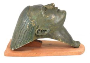 A green patinated plaster model of a gentleman's head, in the Art Deco manner, mounted on a pine