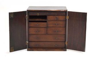 A 19th century mahogany collector's cabinet, the two doors enclosing eight drawers, on a plinth