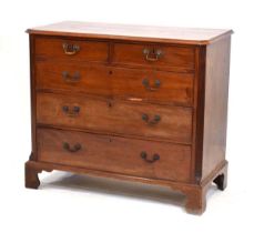 An early 19th century mahogany chest of drawers, the chamfered surface over two short and three long