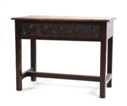 A Provincial oak side table with chamfered edges and Victorian-carved single frieze drawer, on