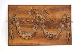 A late 19th century panel decorated with carved relief foliate swag, 113 x 72 cm *The Estate of