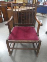 An 18th century and later oak armchair with a spindle back on a sleigh-type base *The Estate of