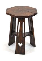 An Arts & Crafts oak side table, the octagonal surface on three supports with heart cut-outs, w.