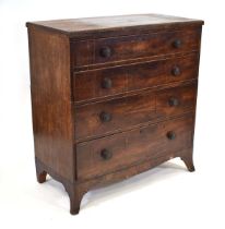 An early 19th century mahogany chest, the surface with beaded mouldings over four long graduated