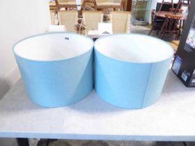 Pair of cylindrical teal coloured lamp shades