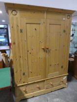 Pine bedroom suite comprising a large double door wardrobe with 2 drawers to base and matching