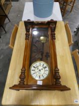 Mahogany cased wall clock with pendulum and weights and decorative turned finials (key and weights