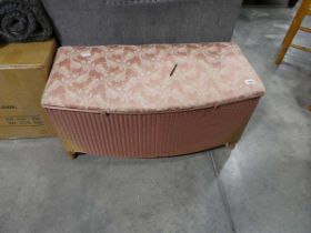 Pink upholstered Lloyd Loom ottoman