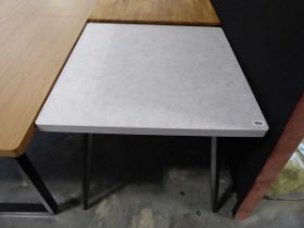 Modern grey dining table on black tapered supports