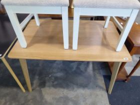 Modern light oak dining table on tapered supports