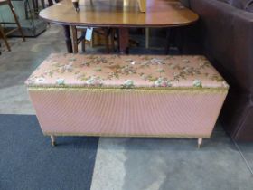 Pink and gilt Lloyd Loom ottoman with floral top