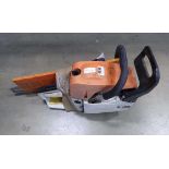 Orange petrol powered chainsaw