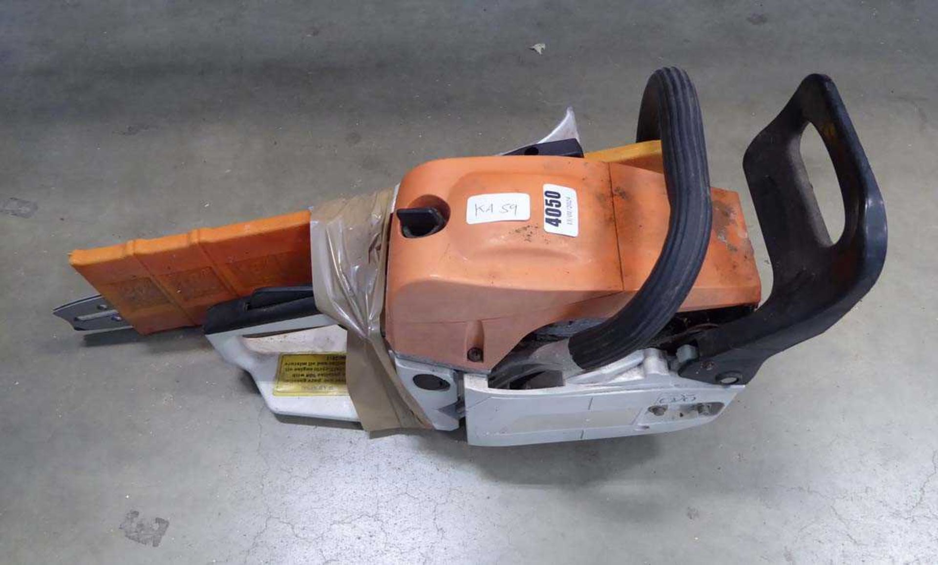 Orange petrol powered chainsaw