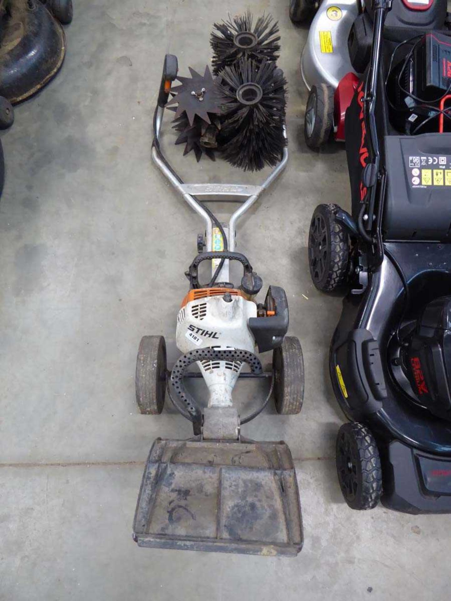 Stihl petrol powered mini tiller with tiller and brush attachments