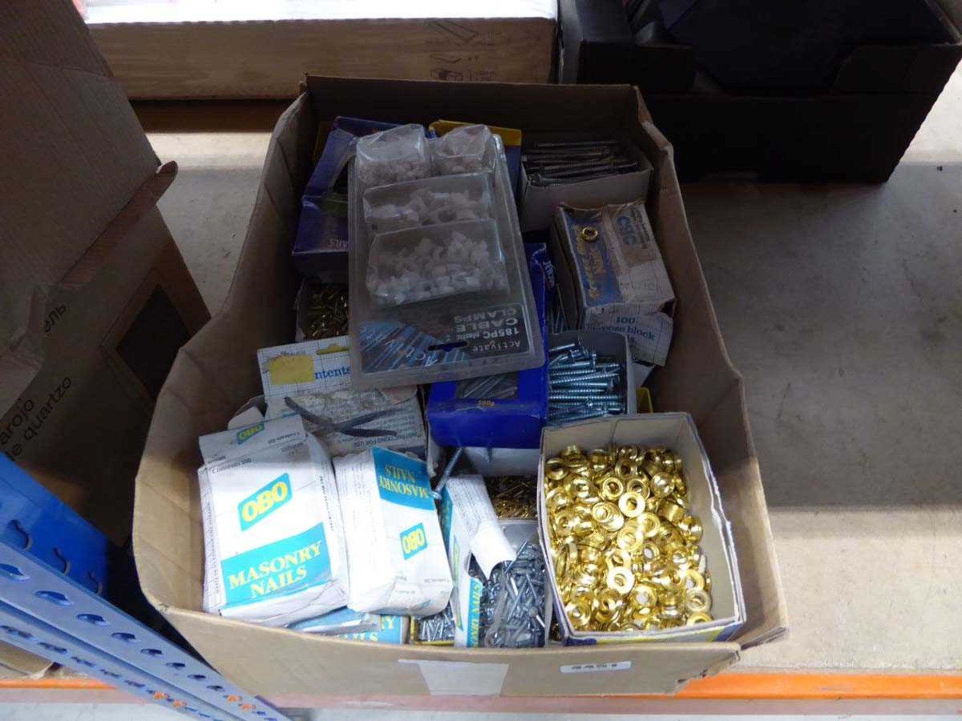 Box containing screws, cable clips, and brass shelf collars