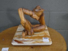 Carved wooden frog on marble base