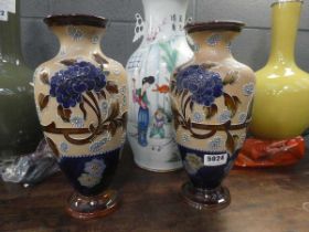 A pair of Doulton Lambeth vases of baluster form, each decorated with chrysanthemum on a buff