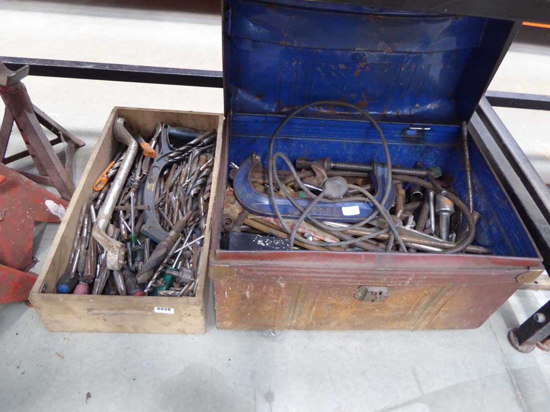 Box of drill bits and metal trunk of tools