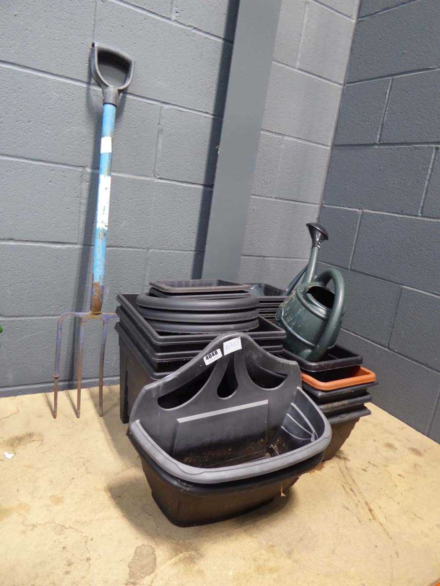 Qty of plastic garden pots and fork with 2 small watering cans