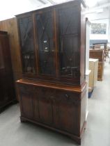 Reproduction yew glazed bookcase with cupboard base under