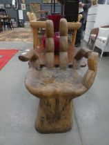 Carved hand shaped armchair
