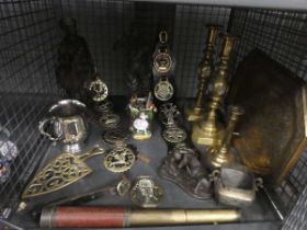 Cage containing horse brasses, trivet, brass candlesticks, tray and ornamental figures