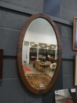 Oval bevelled Arts & Crafts mirror in copper frame