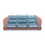 A Danish teak lattice tray with nine detachable moulded glass dishes, designed by Jens Quistgaard,