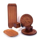 A group of six Danish teak trays including one by 'Silva' together with a pair of teak cuboid