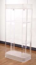 An illuminated 1970's lucite etagere or stand with a 'frozen ice' plinth and rim, 79 x 44 x 168
