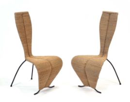 In the manner of Tom Dixon, a pair of woven 'S' style chairs with black tubular frames