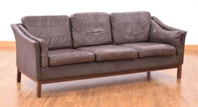 A 1970's Danish brown leather three-seater sofa on mahogany legs *Sold subject to our Soft
