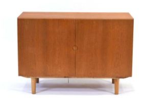 A 1960's Danish oak two door cupboard with a circular inset handle, Bramin System 160 Range, label
