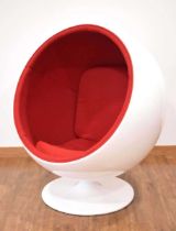A late 20th century white moulded chair with a red fabric upholstered interior, on a circular