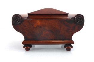 A mid-19th century rosewood tea caddy of sarcophagus form in small proportions with scrolled