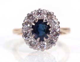 An 18ct yellow gold and platinum highlighted cluster ring set round cut sapphire within a border