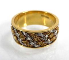 An 18ct two colour weave design band ring, band w. 7 mm, ring size L 1/2, 5.4 gms Some minor signs