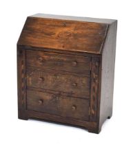 A small oak and marquetry bureau, the fall front over a solid door enclosing shelves to the